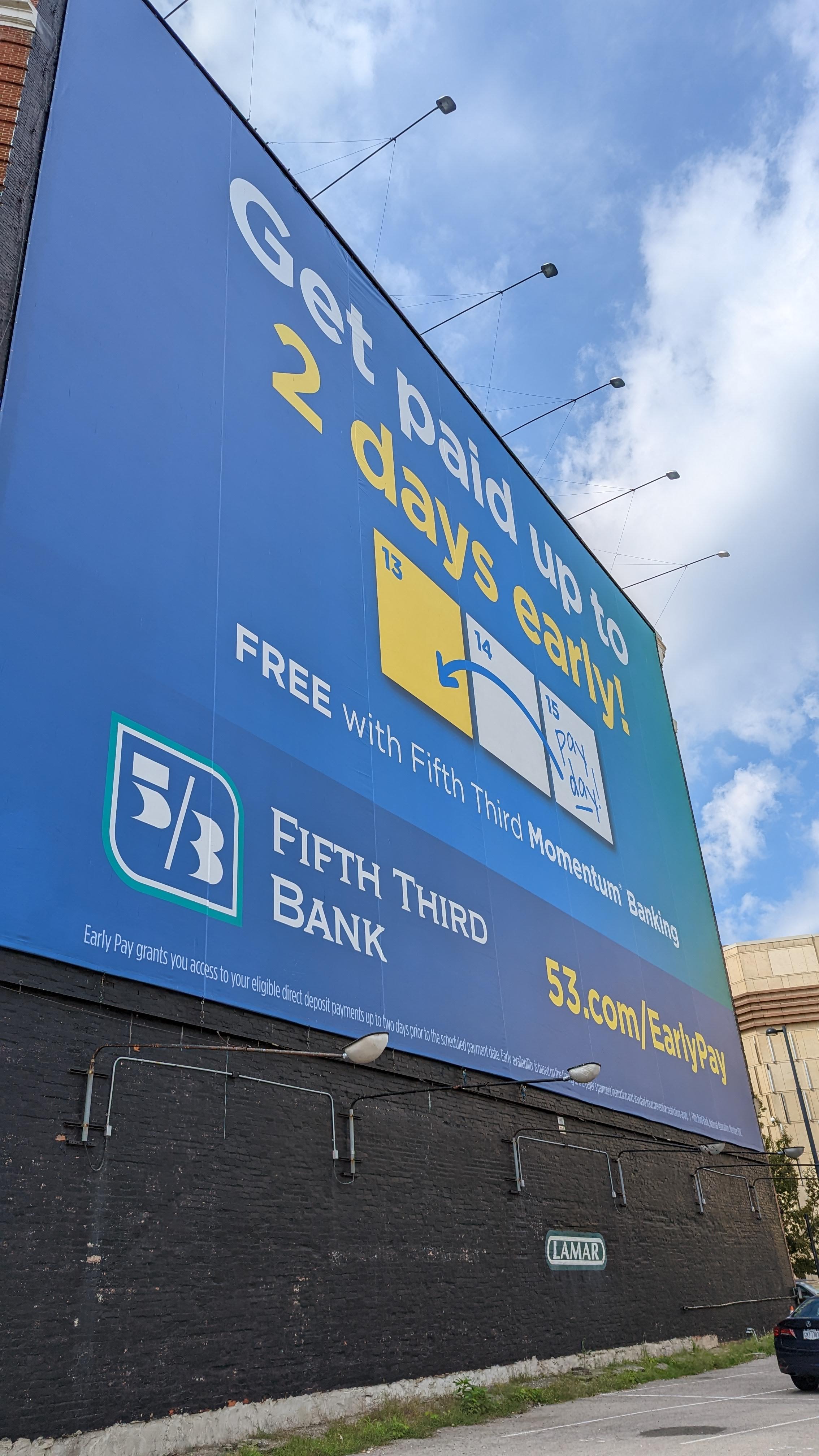 Blue billboard from the bank 5/3rd advertising a product that allows you to get paid two days early