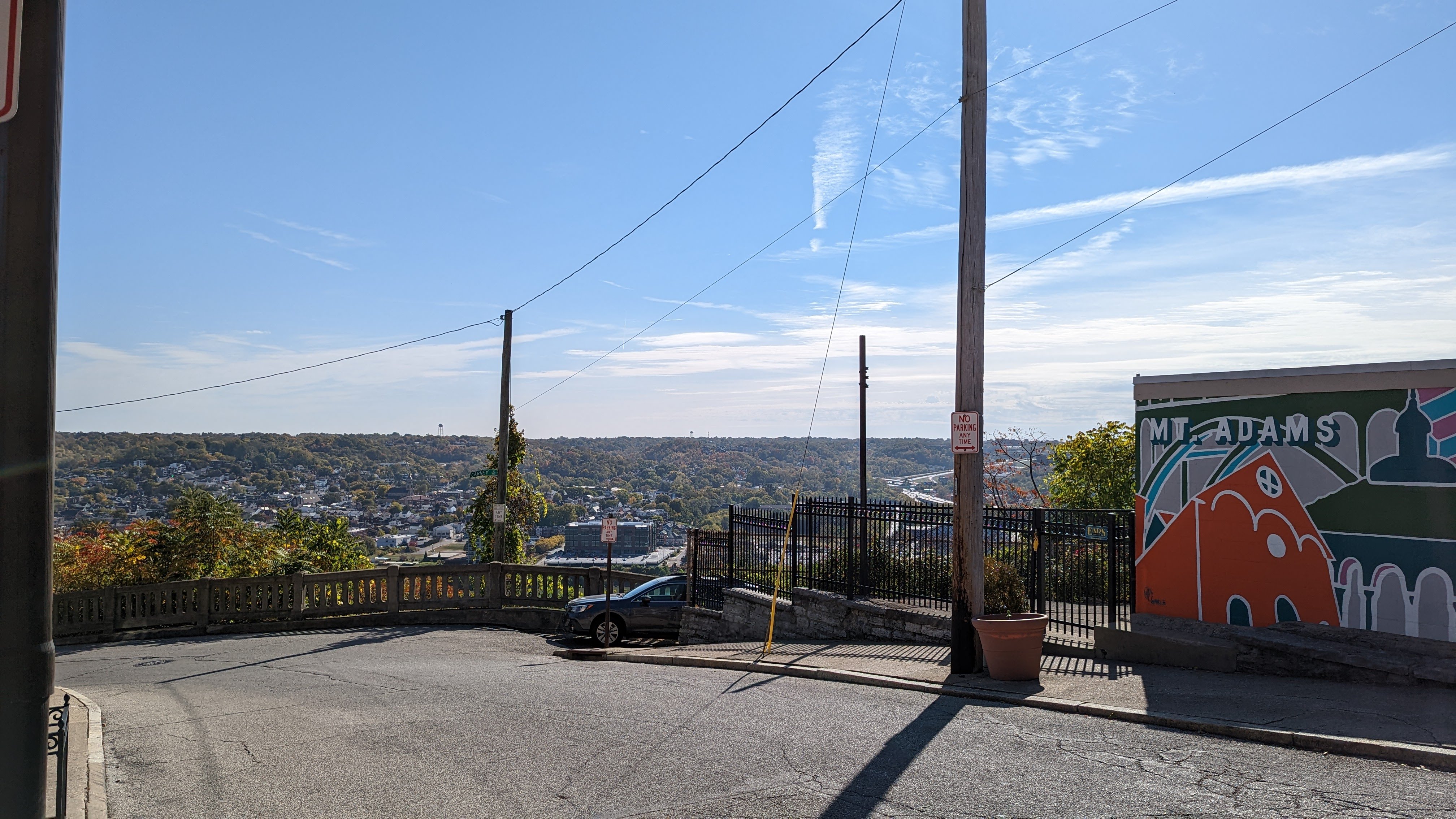 Photo of neighborhood in the distance, Mount Adams mural on right