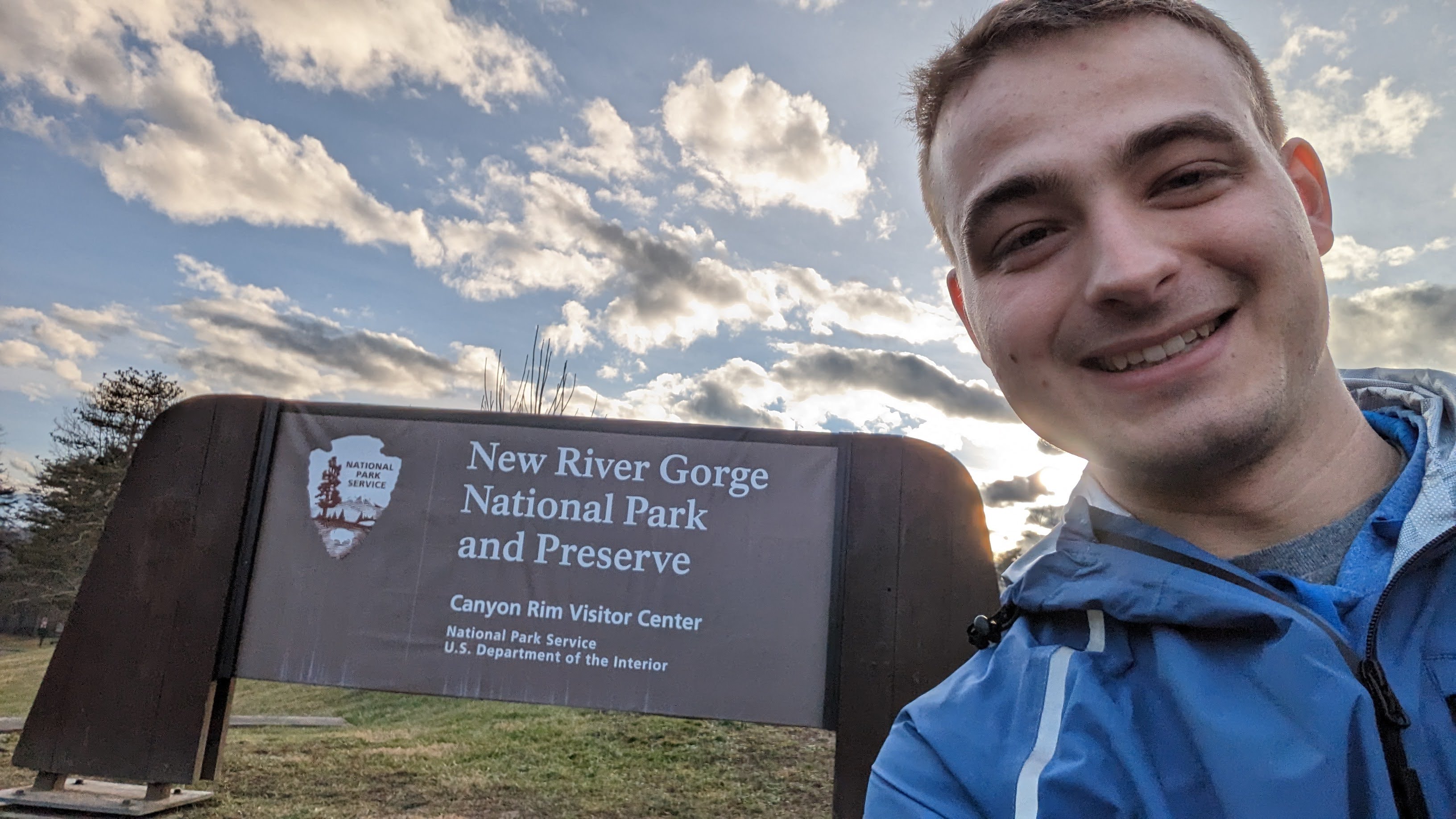 A picture in front of the new river gorge welcome sign